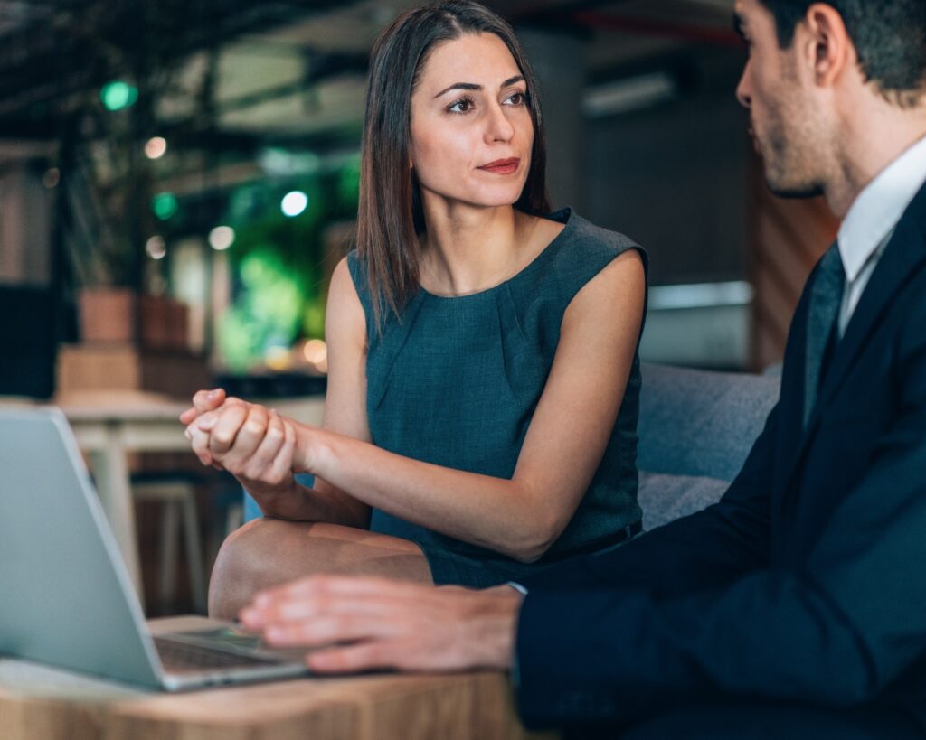 workplace sexual harassment image of a man and woman in an office